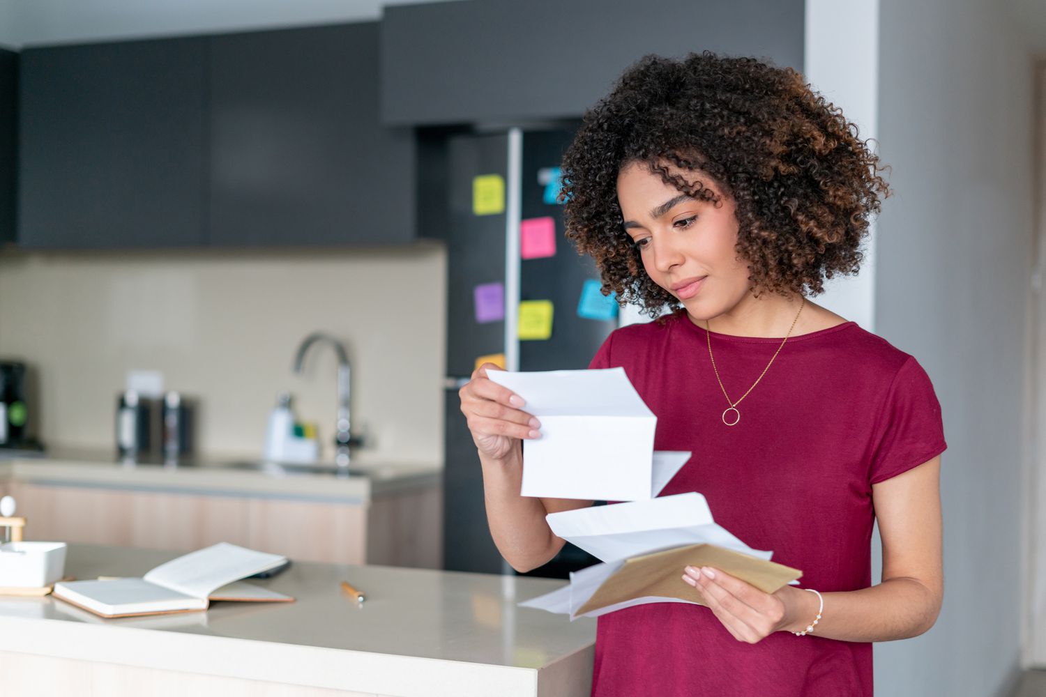 A woman looks through mail.