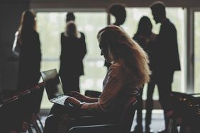 Businesswoman using laptop in conference room