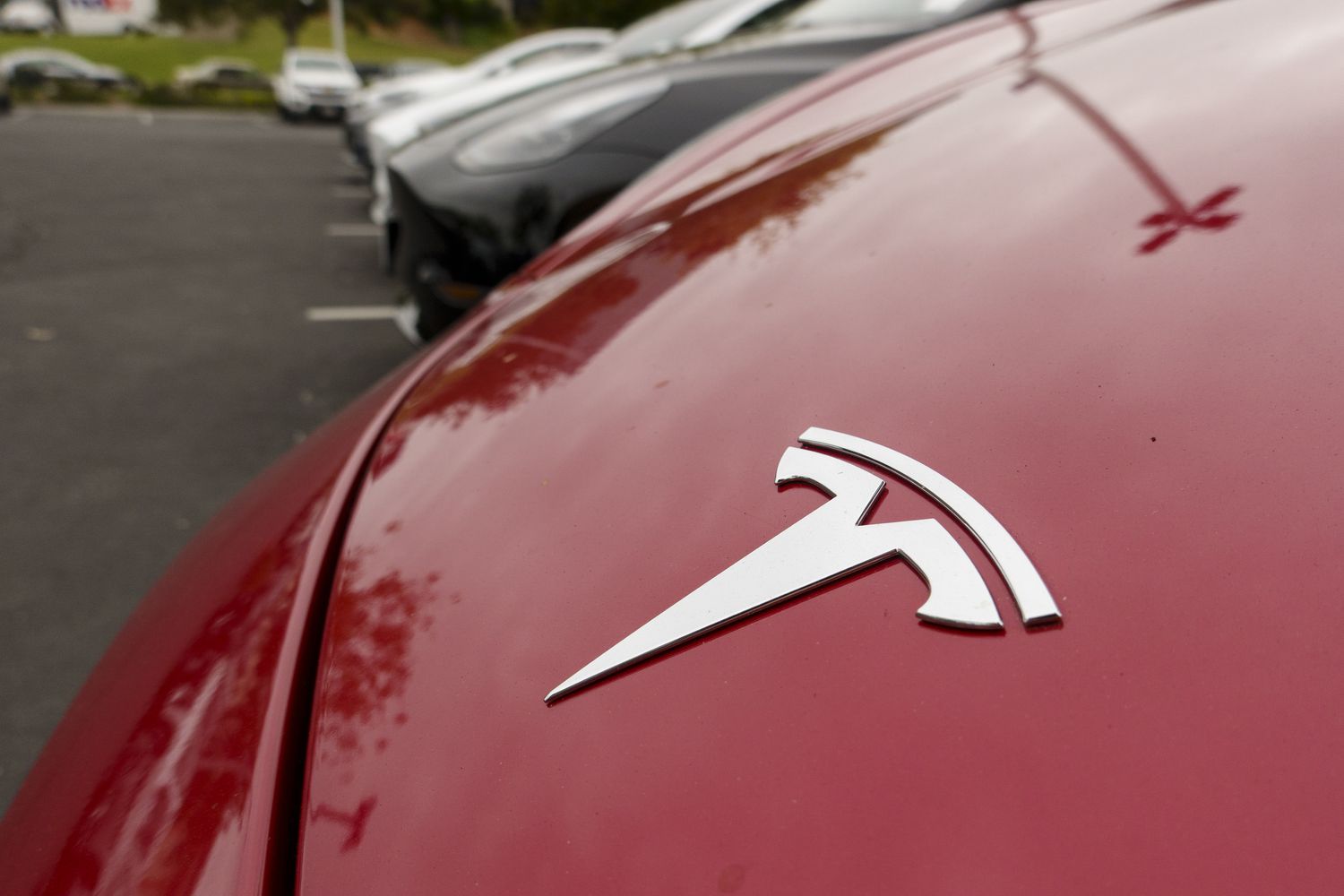 A Tesla logo is displayed on a truck for sale.