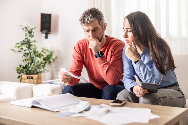 Man and woman looking at their credit card debt.