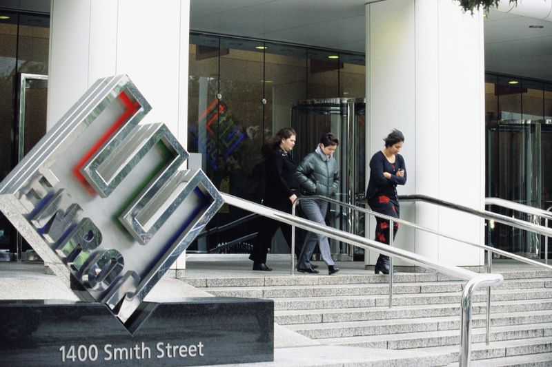 Front view of Enron Headquarters with people walking out of the building