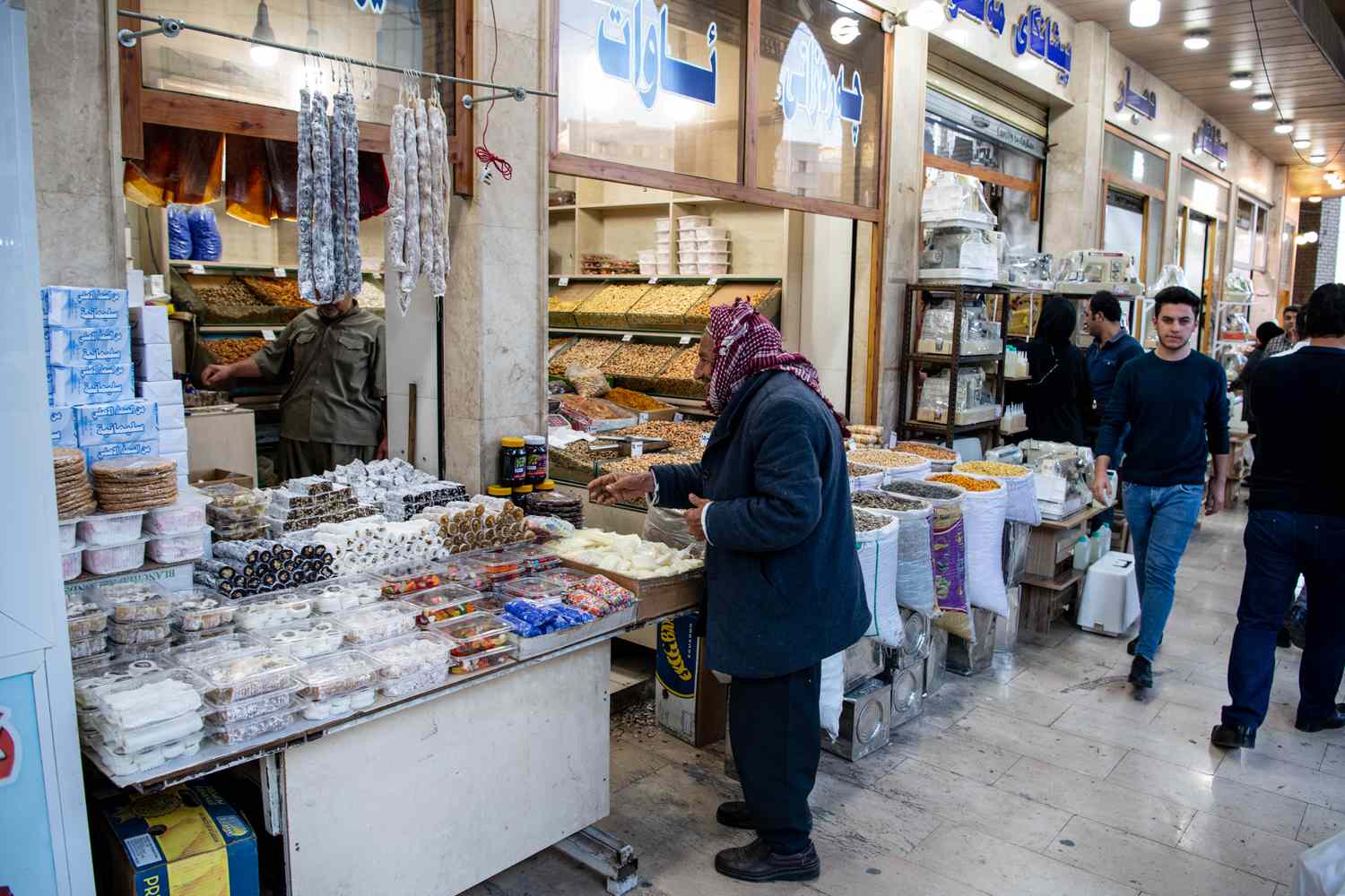 A man shopping in a street market in Iraq