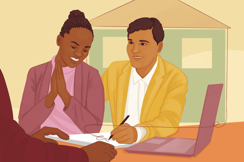 Woman and man sitting together at a table, signing mortgage paperwork.