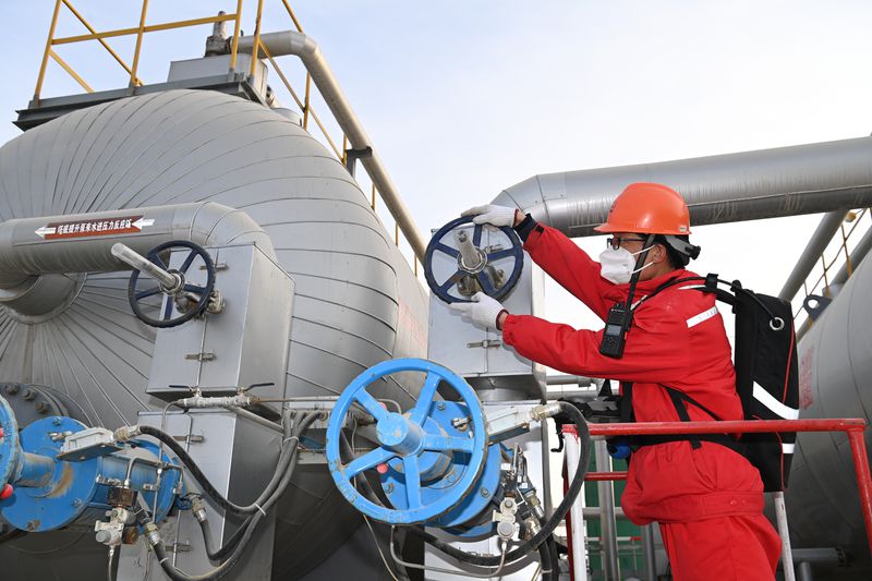 Engineer inspecting pipes in an oil and gas facility