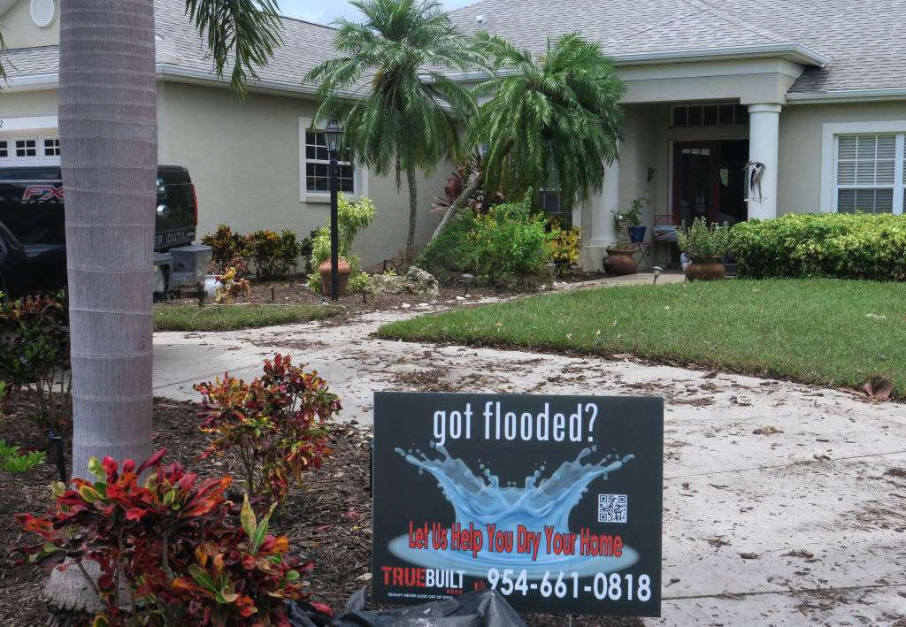 A sign for a water restoration company is seen in front of a home in the Laurel Meadows neighborhood which was flooded by rains from Tropical Storm Debby on August 10, 2024 in Sarasota, Florida.