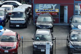 Cars are parked in a lot. 