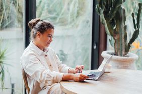 A woman reading about the best crypto software wallets