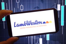 The Lamb Weston logo is seen on a phone screen, with a stock chart in the background.