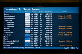 A departure board displays some flight delays and cancellations from Terminal A of Newark Liberty International Airport, on May 6, 2025, in Newark, New Jersey