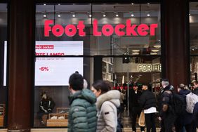 People walk past a Foot Locker store in Milan, Italy, in March. 