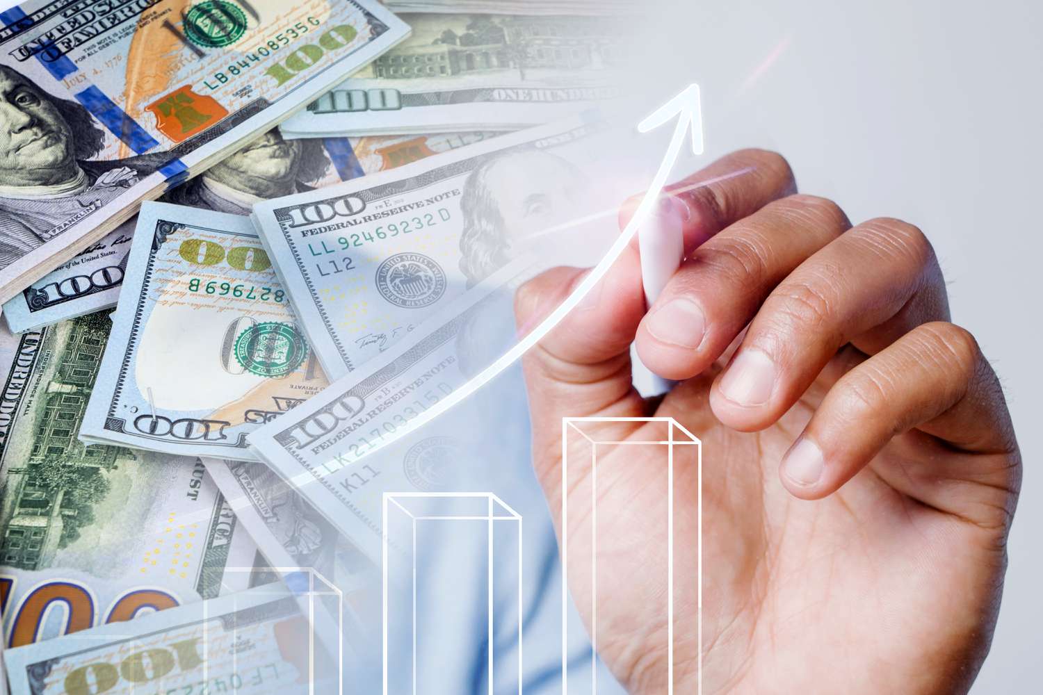 A person's hand tracing an arrow upward like on a chart against a background of US currency.