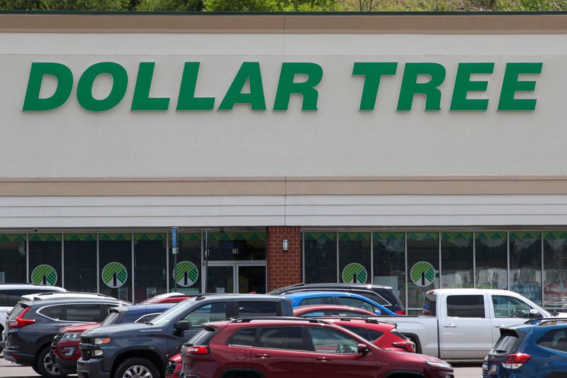 Cars and trucks are seen in front of a Dollar Tree store.