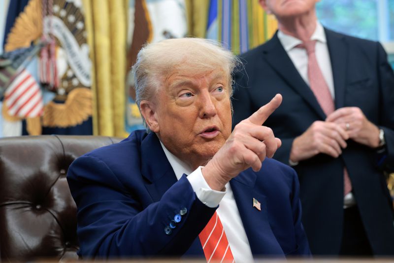 President Donald Trump addresses reporters in the Oval Office at the White House.