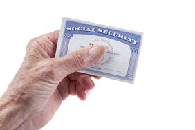 Woman’s hand holding Social Security card