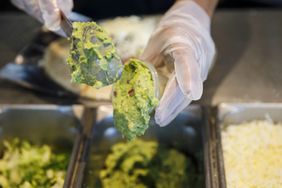 An employee scoops guacamole at a Chipotle Mexican Grill Inc. restaurant in El Segundo, California