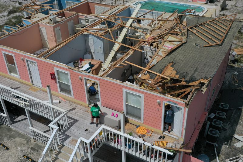  An aerial view from a drone shows Jamie Cade (L) waiting as her mother Jody Wright walks into her damaged apartment after the roof was damaged when Hurricane Sally passed through the area on September 17, 2020 in Perdido Key, Florida. 