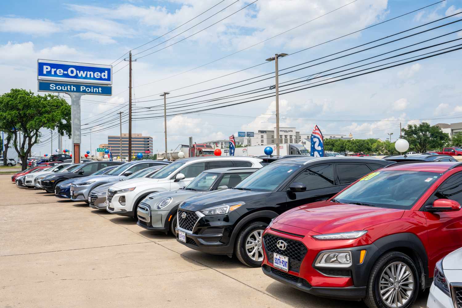 Cars are parked at a dealership. 