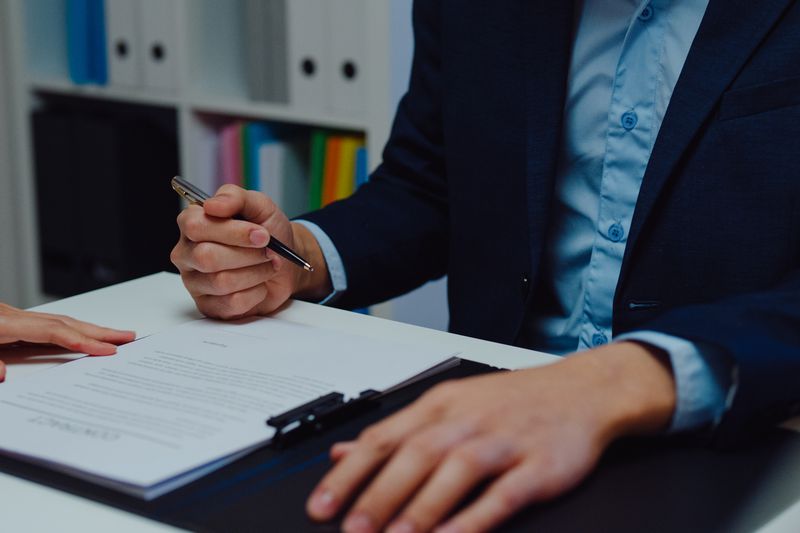 A businessperson signing a document