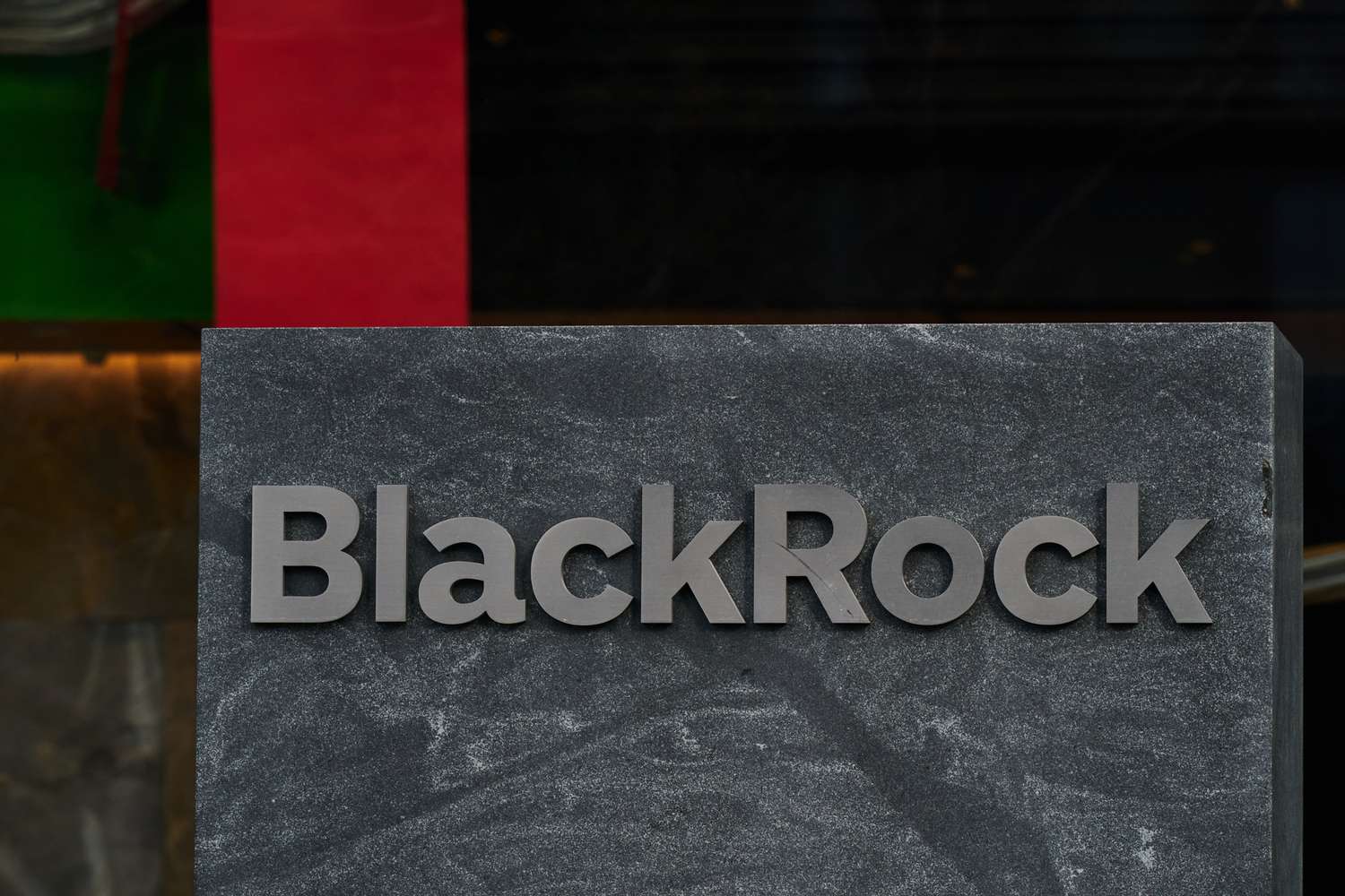The BlackRock logo is seen on a sign outside of an office building.