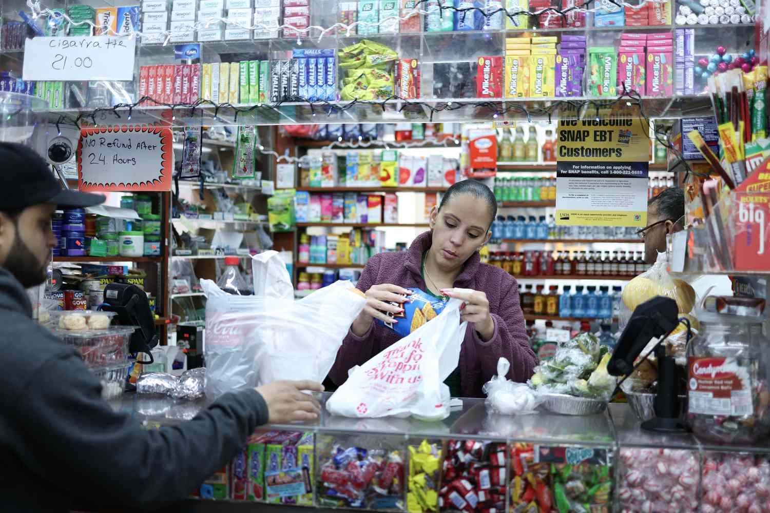People buys items in a bodega in the Bronx borough of New York City on February 27, 2025. 