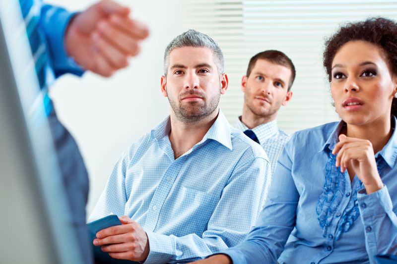 Group of business people during business seminar, listening to presentation.