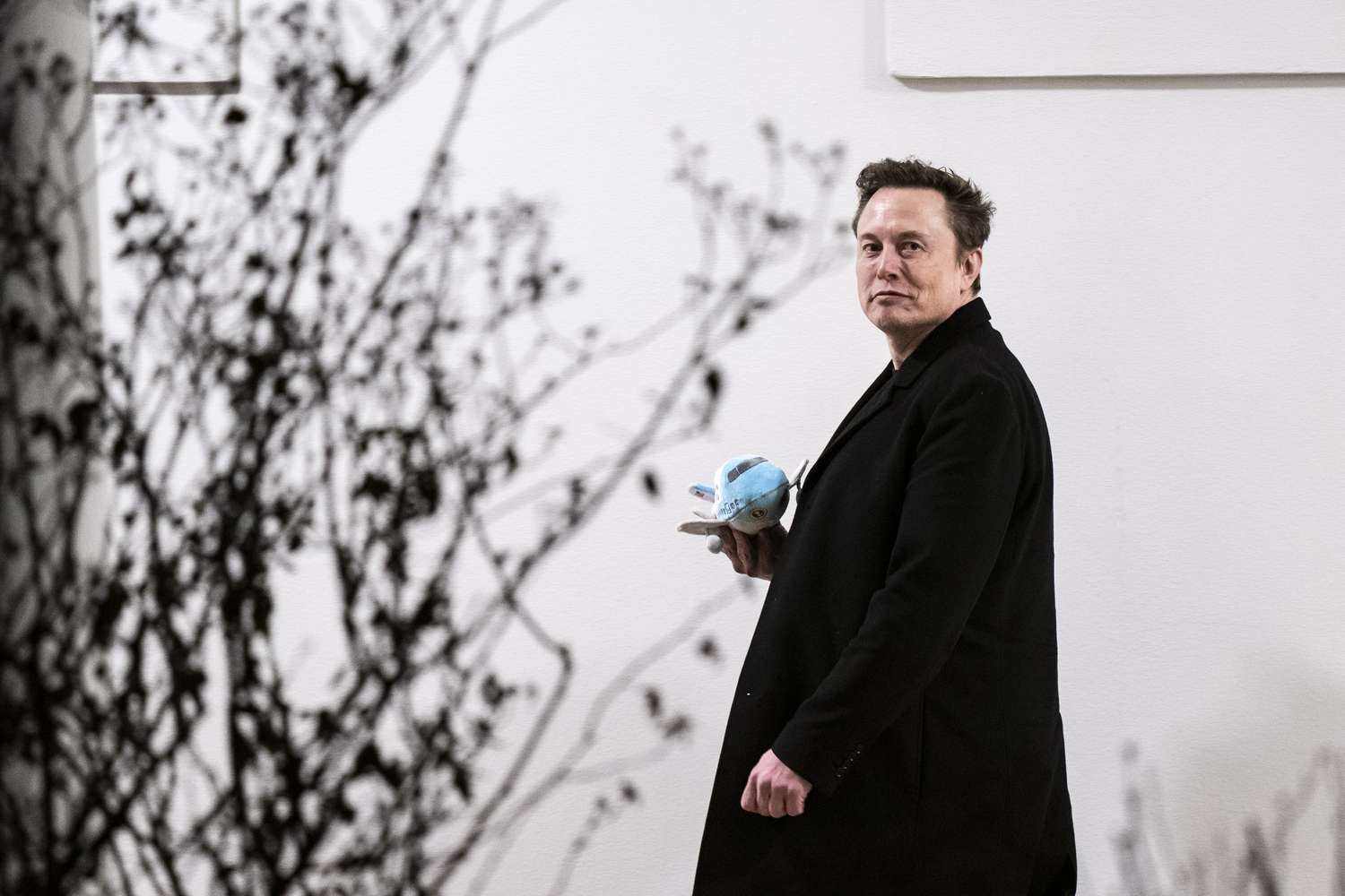 Elon Musk holding a stuffed Air Force One