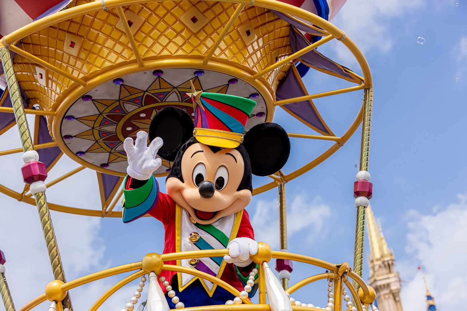 Mickey Mouse waves to the crowd in Magic Kingdom Park at Walt Disney World 