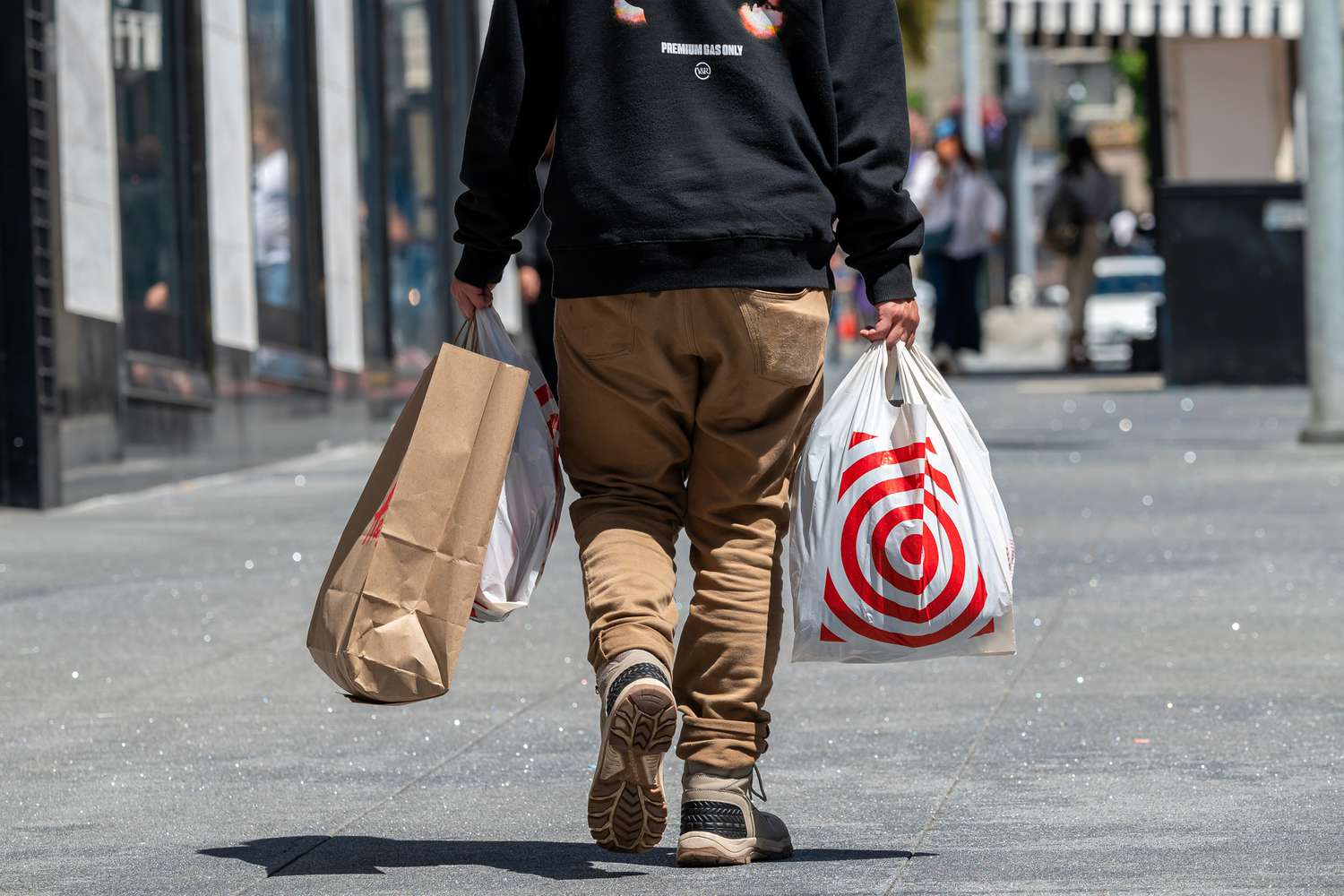 A shopper carries Target and H&M bags in San Francisco, California, US, on Thursday, July 25, 2024. 