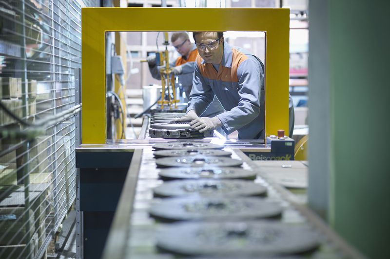 Workers on production line in industrial clutch factory