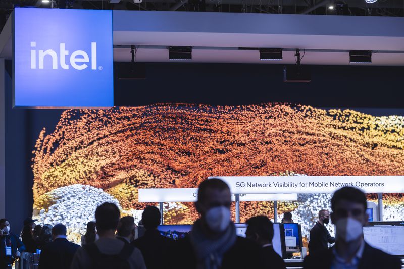 Intel logo hangs above crowd in conference center.