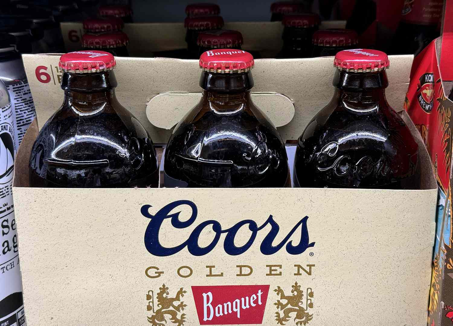 Bottles of Coors beer on a store shelf. 