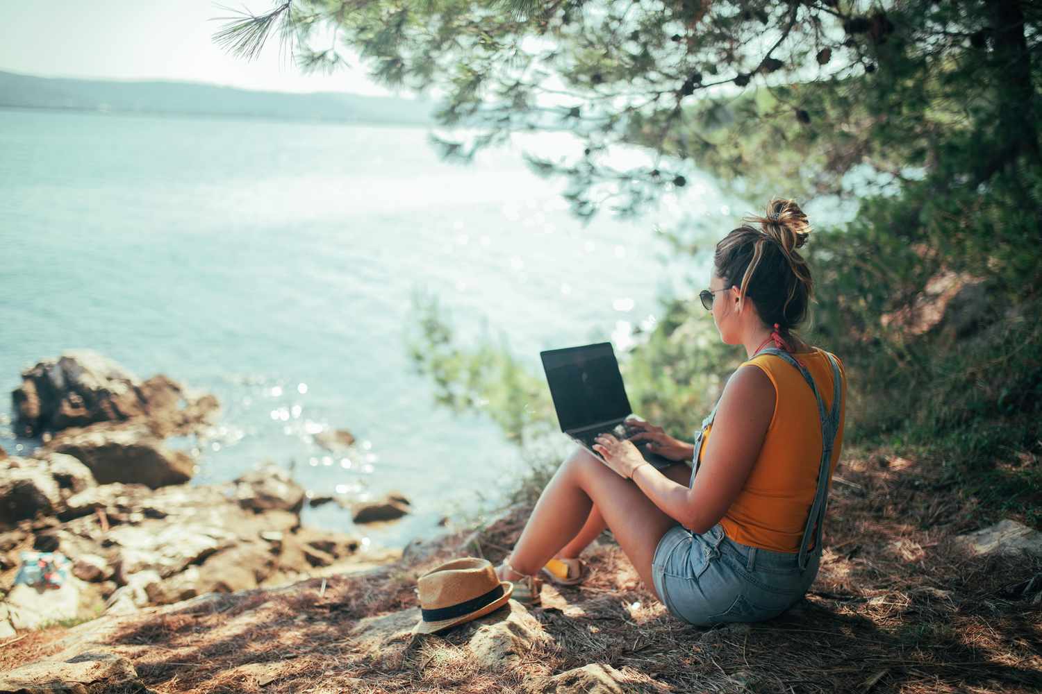 Woman working in a country that offers a digital nomad visa.