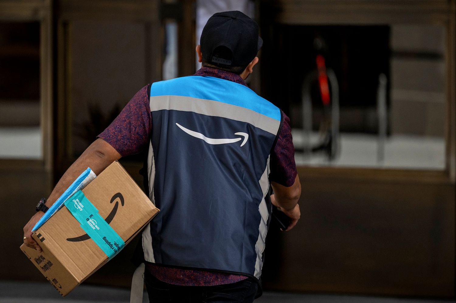 An Amazon worker delivers a package.