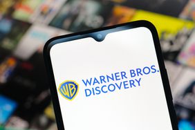 The Warner Bros. Discovery logo is seen displayed on a smartphone screen