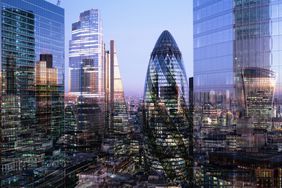 U.K., London, multiple-exposure, elevated view of high-rise financial buildings in the city, illuminated at dusk