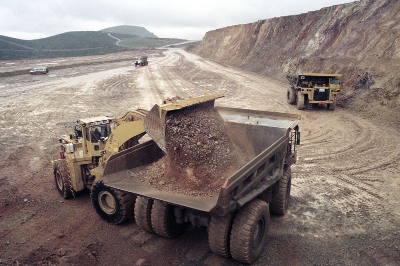 Dirt containing micro-particles of gold is loaded onto a dump truck at a Newmont Gold Company mine.