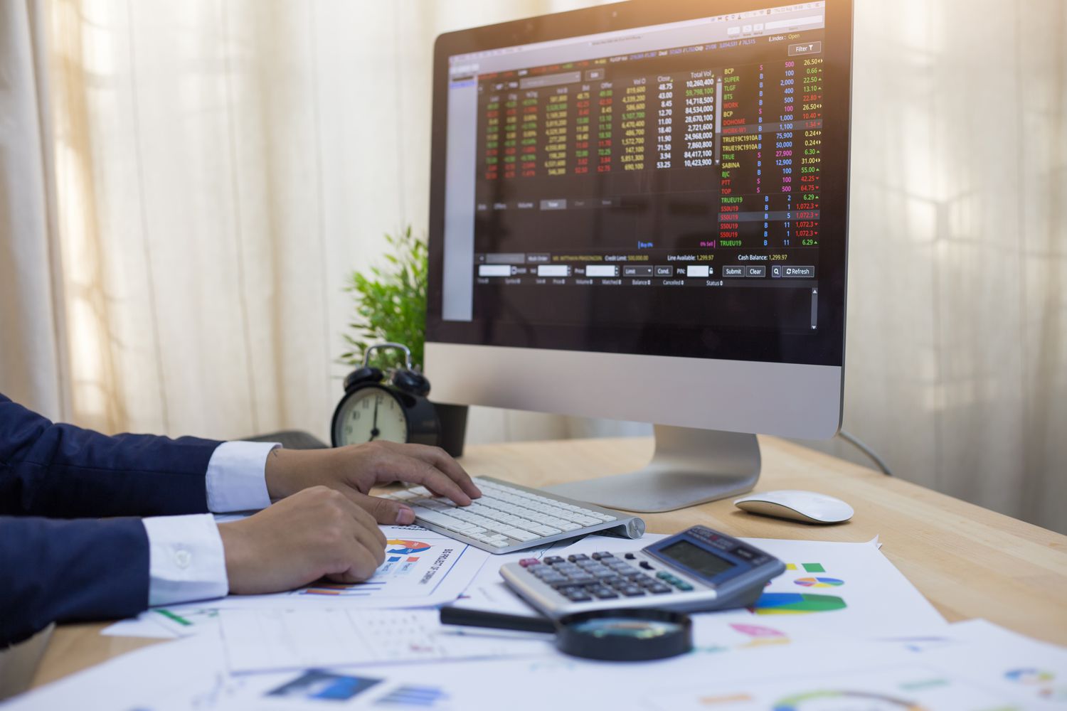 An accountant works with a computer to double check the listed price of foreign assets that will be included in the company financial report.