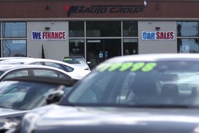 A "We Finance" sign is posted at an auto dealership in California. 