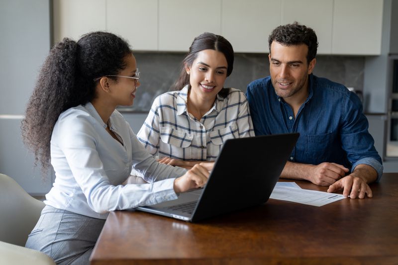 Couple speaking to a financial advisor about finances.