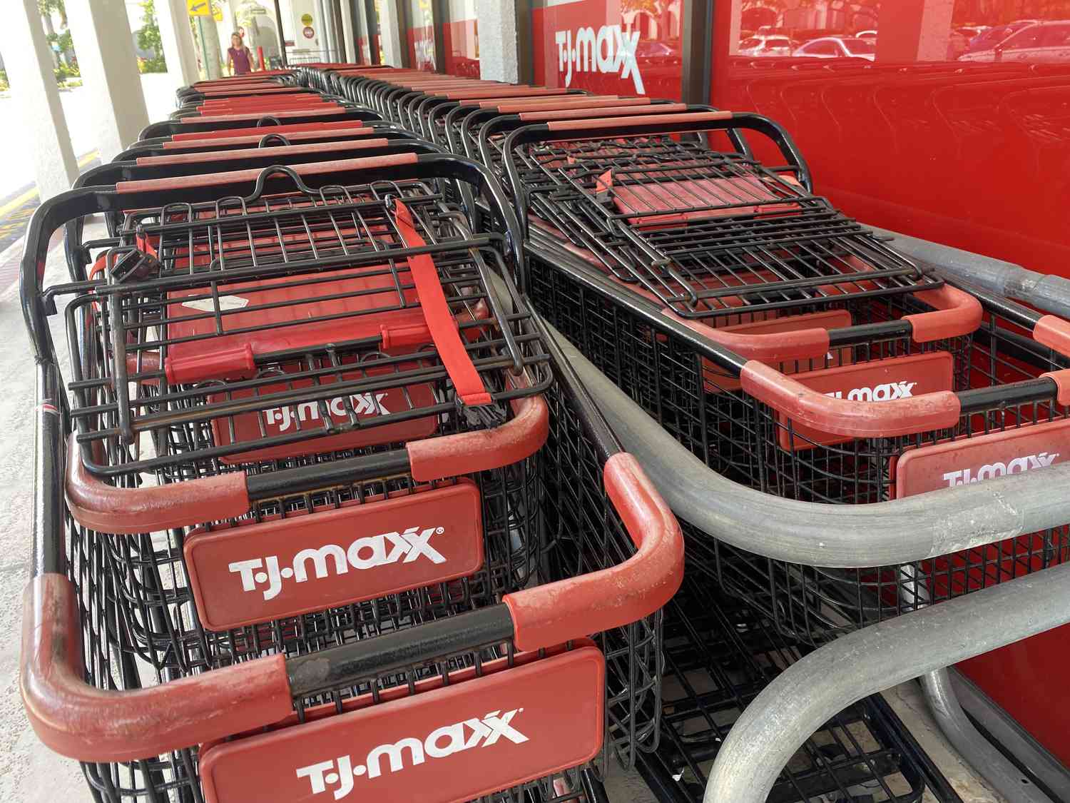 The TJ Maxx logo is seen on several shopping carts outside a TJ Maxx store.