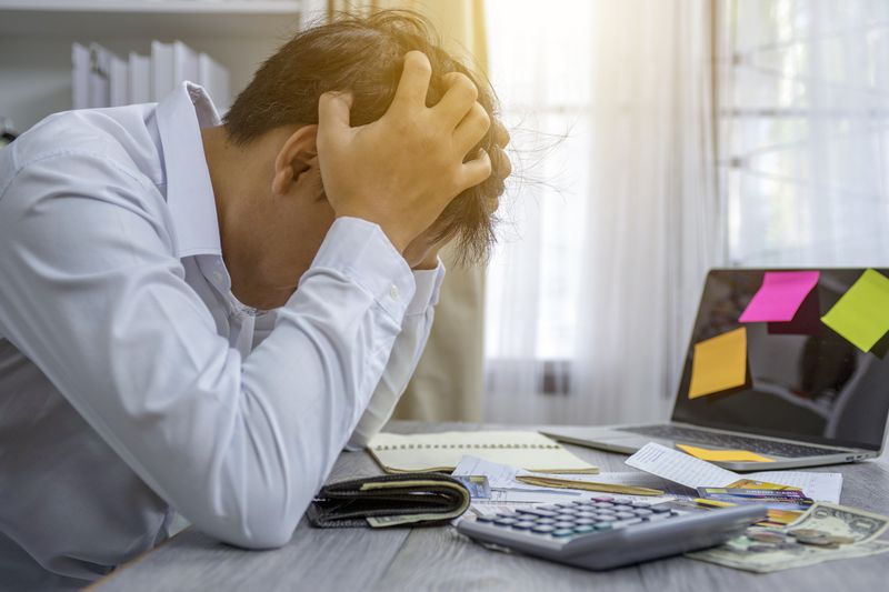 Person stressed about debt