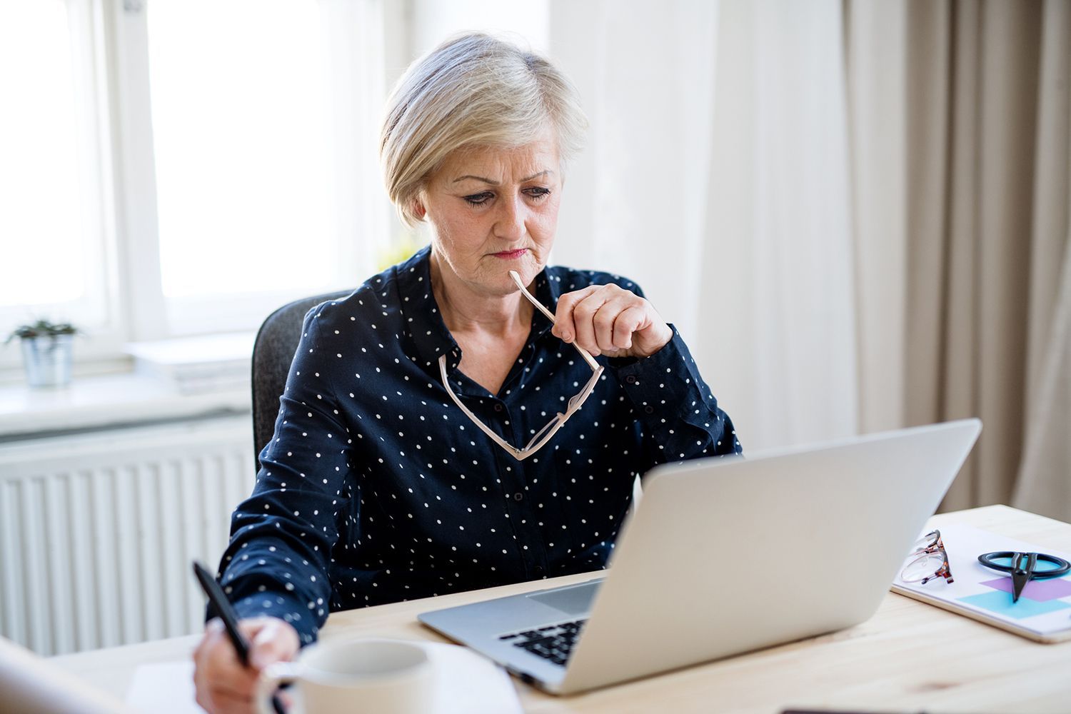 A worker with glasses at a laptop