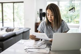Woman with papers and a laptop