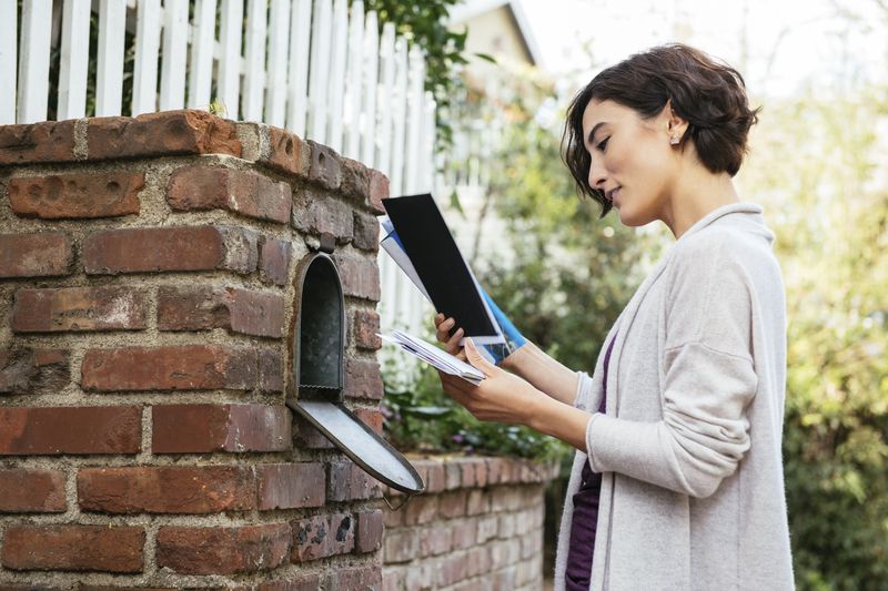 Woman checking her mailbox for her FAFSA award letter