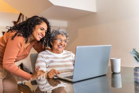 A younger woman and an older woman at a computer