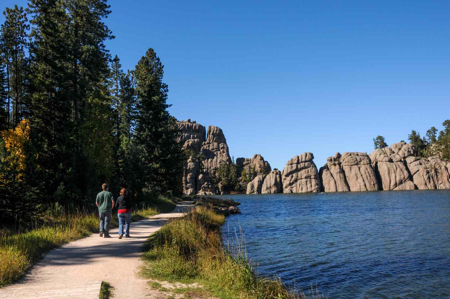 Two people walking in Custer State Park - Sylvan Lake Hike - Trail Beside the Lake