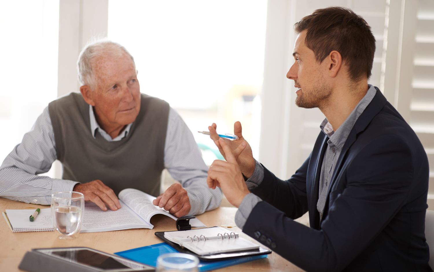 A retirement advisor explaining retirement plans to a retiree
