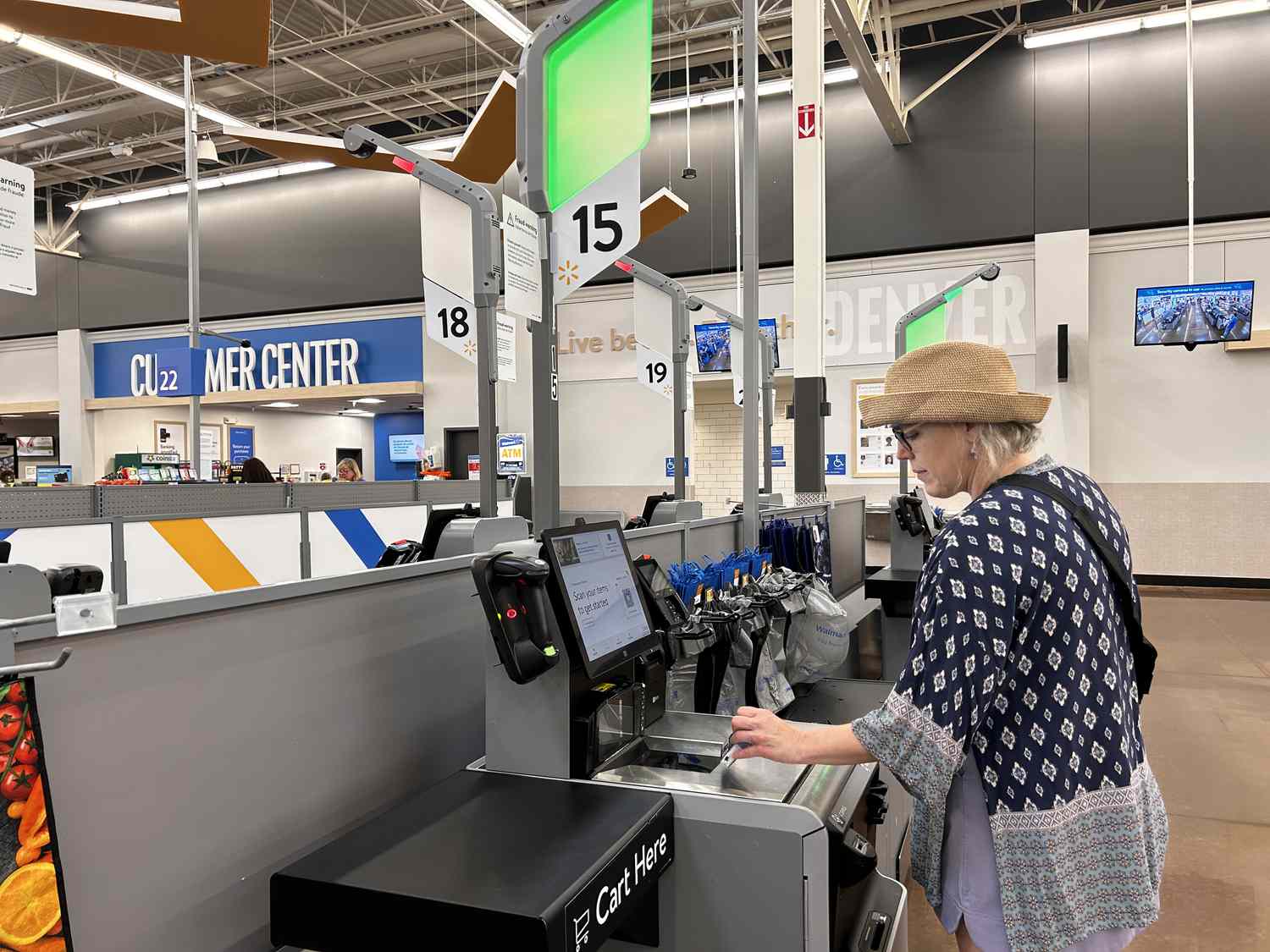 Woman scanning item at self service checkout, Walmart megastore, North Carolina.