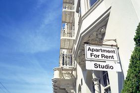 "Apartment for Rent" sign on a building