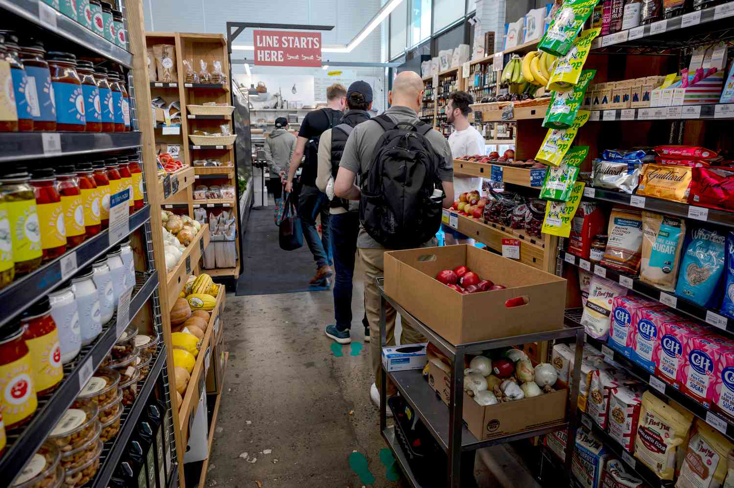 Customers wait to pay at a grocery store in San Francisco, California, on, June 7, 2024. 